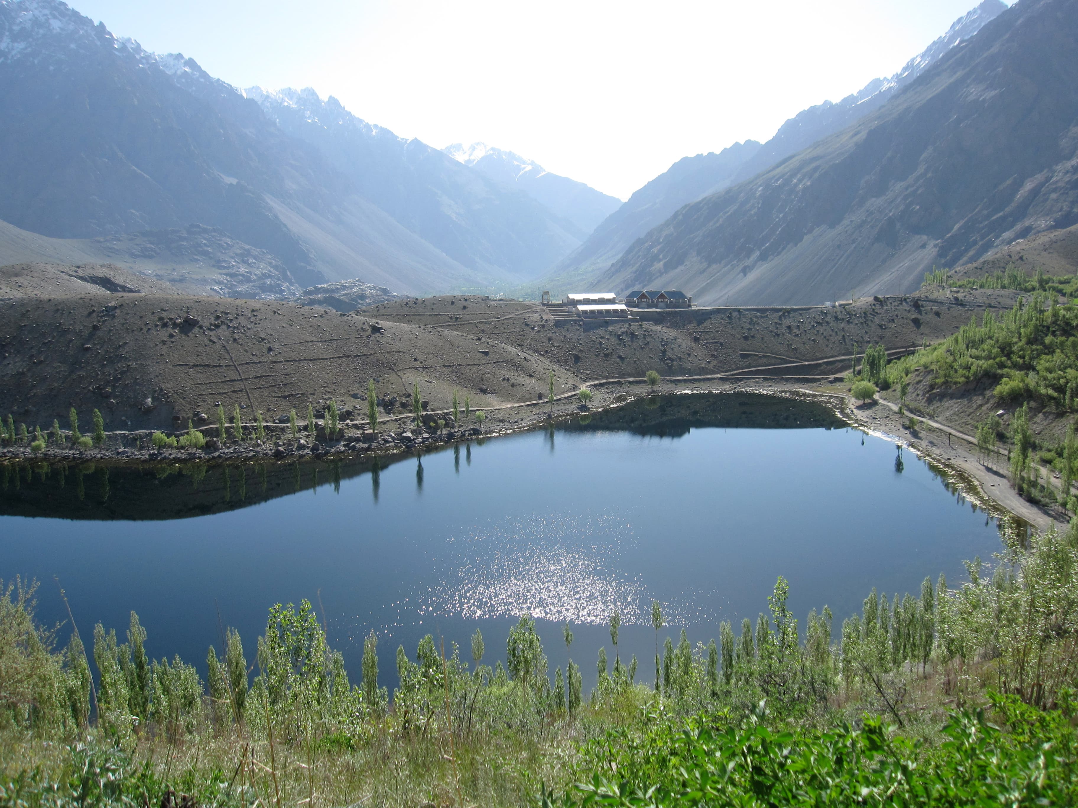 Phander Lake's blue water surrounded by poplar trees and peaks